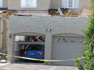 The garage roof from this relatively newer home in Woodbridge or Maple, Ontario was lost in one of two F2 tornadoes that tore through Vaughan on August 20, 2009. Where did the roof go? It stuck the neighbour’s home, doing extensive damage.