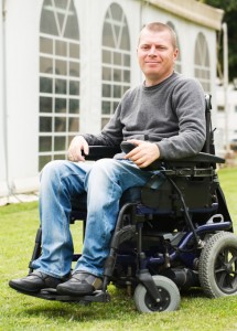 Disabled men smiling in a wheelchair