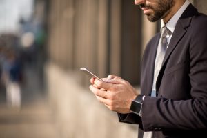 Businessman with mobile phone and smart watch