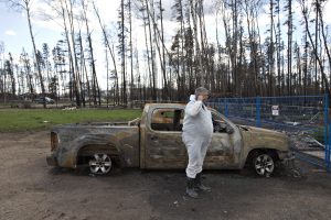 Wade Wilson talks on the phone by his burnt up truck at his home in Saprae Creek near Fort McMurray Alta., on Friday June 3, 2016. Members of the community are now being allowed back into their homes. THE CANADIAN PRESS/Jason Franson