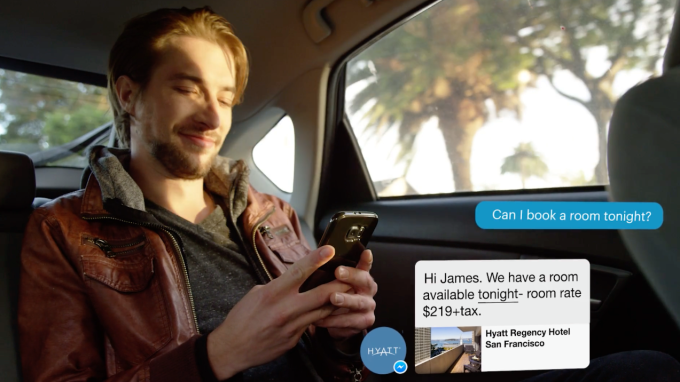 A man uses a messaging app to book a hotel with a chatbot.