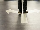 Feet and two arrows painted on floor