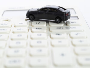 Calculator and toy car on white background